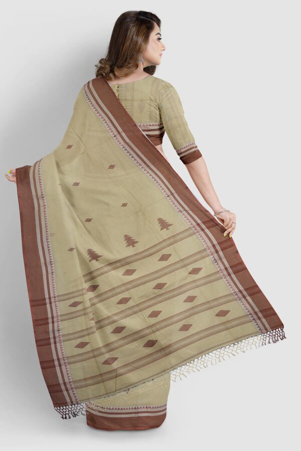 Khaki cotton handloom saree with chocolate Tangail border draped elegantly