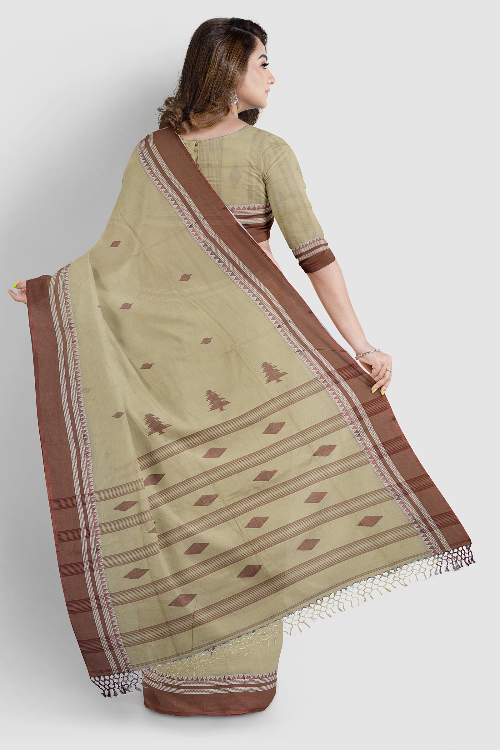 Khaki cotton handloom saree with chocolate Tangail border draped elegantly