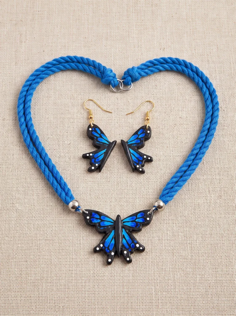 Peacock blue terracotta earrings with hand-painted butterfly motif
