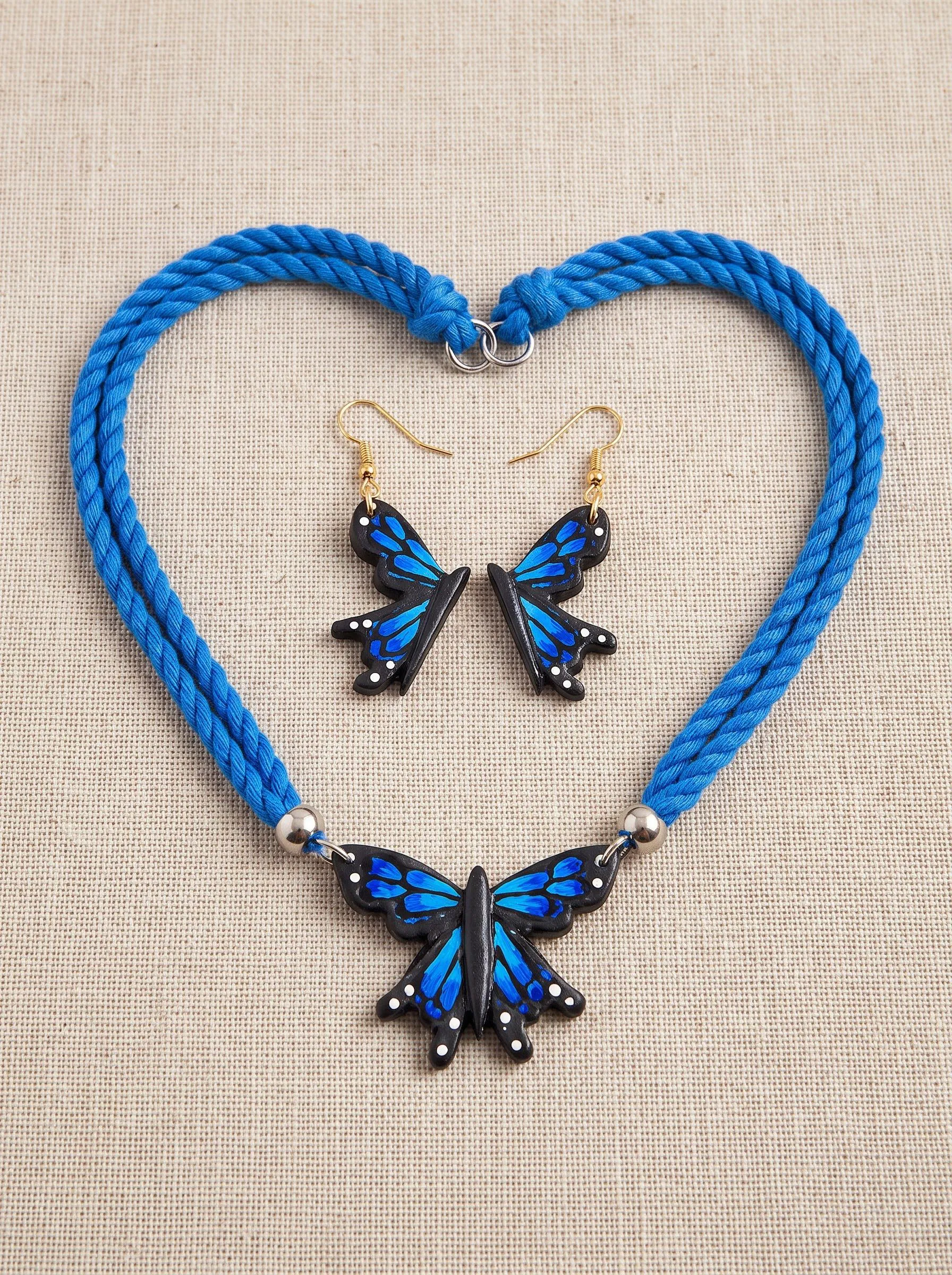Peacock blue terracotta earrings with hand-painted butterfly motif